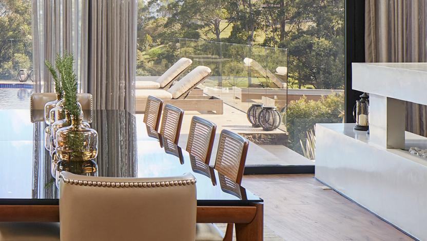 HomeWorks luxury home integration system in modern dining room with panoramic windows