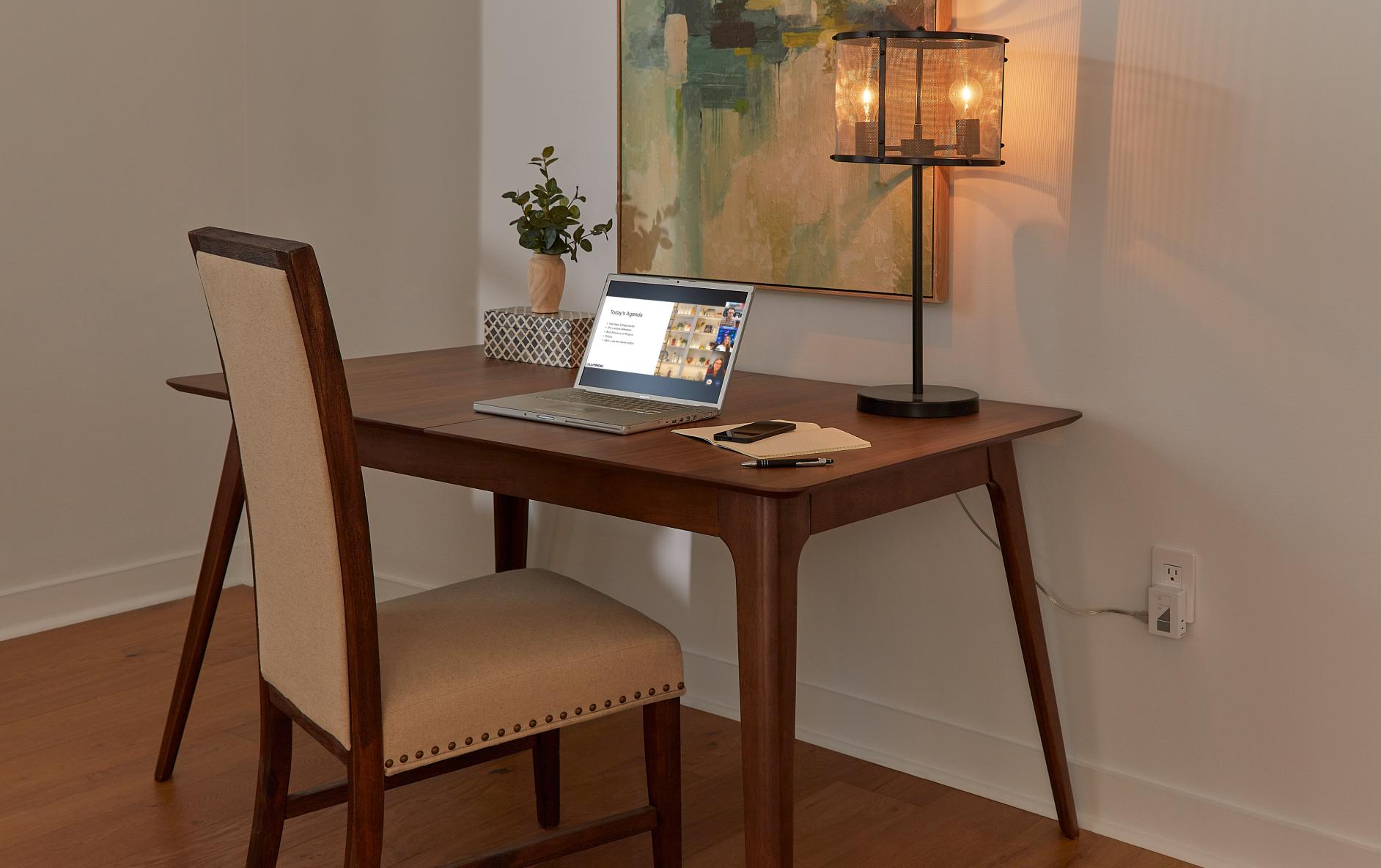 Home office with lap top open to the Lutron Lumaris tape light webinar.